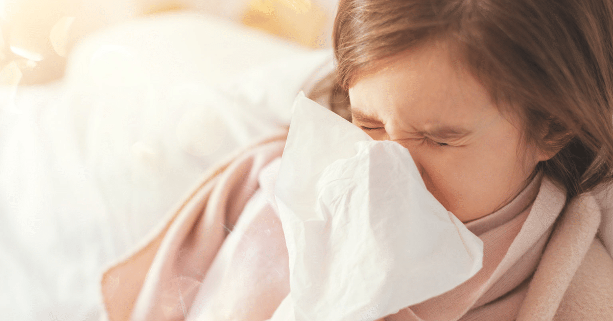 Little girl sneezing: allergies vs virus in kids