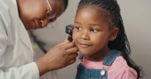 doctor checking for ear infection in kids
