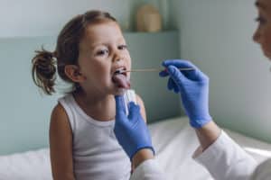 Strep throat in kids test with a little girl