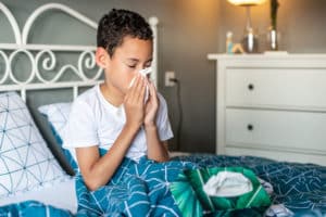 Upper respiratory infections in kids - boy sneezing