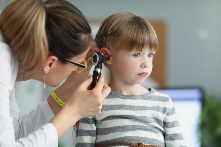 Doctor checking ear infection symptoms in kids