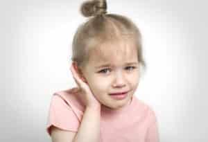 Little girl with ear infection - treating ear infections in children
