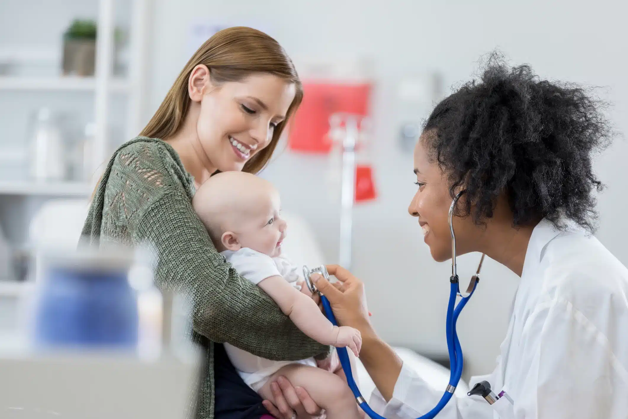 Friendly pediatrician examines baby girl Friendly urgent care pediatrician examines infant
